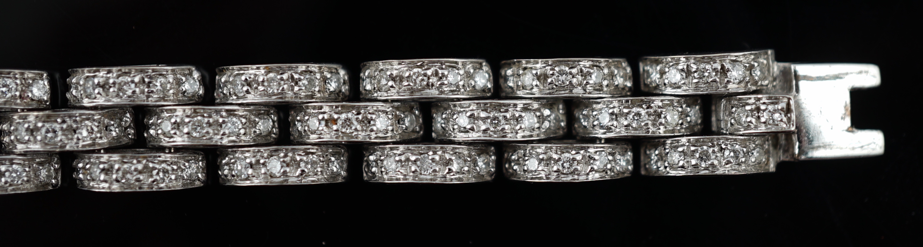 An 18k white gold and diamond chip set triple row bracelet